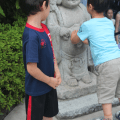 Kids Playing on Buddha&nbsp;Sculpture